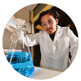 scientist in lab with large flask