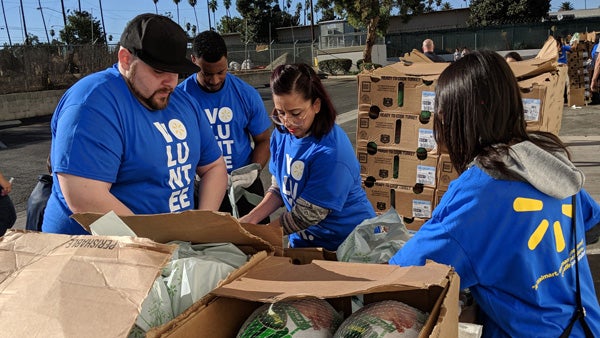 Volunteers packing Walmart turkeys and groceries for families.