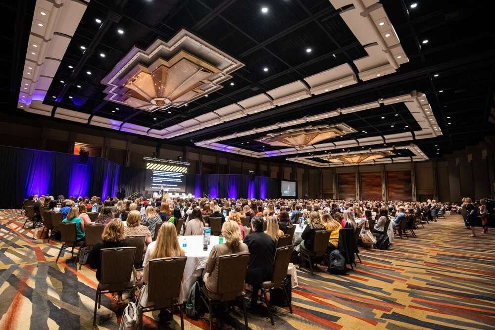 Ballroom filled with women listening to Summit presentations