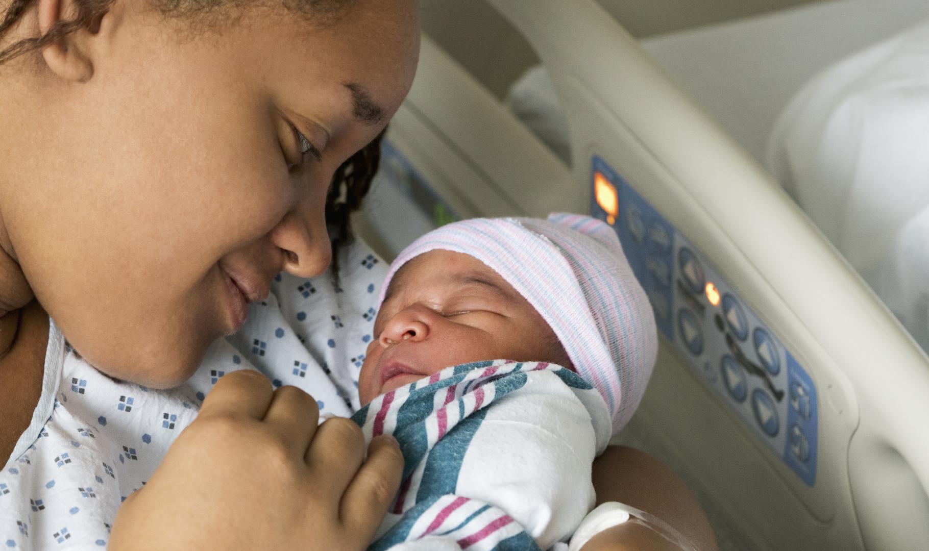 Black mother and her newborn in the hospital